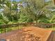 A spacious back deck overlooking green trees at 100 Homestead Pl, Rex, GA 30273