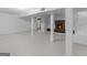 Finished basement featuring an open layout, fireplace, and white-painted floors, creating a versatile living space at 100 Homestead Pl, Rex, GA 30273