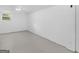 Spacious basement featuring painted concrete floors, bright lighting, and a window for natural light at 100 Homestead Pl, Rex, GA 30273