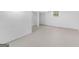 Bright basement area featuring painted concrete floors, white walls, and a small window at 100 Homestead Pl, Rex, GA 30273