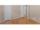 Bright bedroom with hardwood floors, neutral walls, and double closet doors offering ample storage at 100 Homestead Pl, Rex, GA 30273