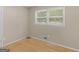 Simple bedroom featuring hardwood floors, a window for natural light, and neutral wall color at 100 Homestead Pl, Rex, GA 30273