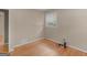 Charming bedroom featuring hardwood floors, neutral walls, and a window letting in plenty of natural light at 100 Homestead Pl, Rex, GA 30273