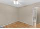 Cozy bedroom with hardwood floors, ceiling fan, neutral walls, and view of the ensuite bathroom at 100 Homestead Pl, Rex, GA 30273