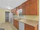 Functional kitchen with ample cabinetry and white appliances at 100 Homestead Pl, Rex, GA 30273