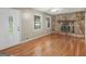 Bright living room with hardwood floors, stone fireplace, and natural light at 100 Homestead Pl, Rex, GA 30273
