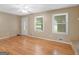 Open living area featuring hardwood floors, ample natural light, and neutral paint at 100 Homestead Pl, Rex, GA 30273