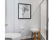 Neutral bathroom showcases a shower, wall art and a wooden stool adding a touch of rustic charm at 118 Meadowview Dr # 09, Temple, GA 30179