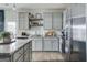 Contemporary kitchen with stainless steel refrigerator and gray cabinetry and granite countertops at 118 Meadowview Dr # 09, Temple, GA 30179
