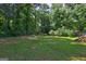 Spacious backyard featuring a swing set, lush greenery, and a well-maintained lawn at 315 Charlotte Blvd, Stockbridge, GA 30281