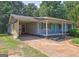 Charming single-story home with a covered front porch, carport, and a bright blue front door at 315 Charlotte Blvd, Stockbridge, GA 30281