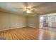 Bright, empty living room featuring wood floors and a ceiling fan, leading into an adjacent kitchen at 315 Charlotte Blvd, Stockbridge, GA 30281