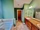 Large bathroom featuring double vanities, a soaking tub, and walk-in shower at 9108 Alden Dr, Locust Grove, GA 30248