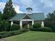 Exterior of a community building on a green lawn with manicured bushes at 9108 Alden Dr, Locust Grove, GA 30248