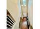 Bright hallway with hardwood floors, modern light fixture, and staircase leading to the upper level at 9108 Alden Dr, Locust Grove, GA 30248