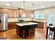 Spacious kitchen boasts a central island, stainless steel appliances, granite countertops, and hardwood floors at 9108 Alden Dr, Locust Grove, GA 30248