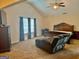 Spacious main bedroom featuring a vaulted ceiling, fan, seating area, and a comfortable king-size bed at 9108 Alden Dr, Locust Grove, GA 30248