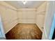 A large walk-in closet with carpeted floors and shelving installed on the walls at 9108 Alden Dr, Locust Grove, GA 30248