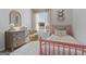 A cozy bedroom featuring a neutral color scheme, a small dresser, and a large window at 122 Meadowview Dr # 11, Temple, GA 30179