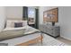 Bedroom features a bed, grey dresser, a colorful picture, and a window at 122 Meadowview Dr # 11, Temple, GA 30179