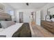 Main bedroom features a large bed, hardwood floors, a dresser, and an adjoining bathroom at 122 Meadowview Dr # 11, Temple, GA 30179