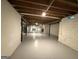 A large unfinished basement with exposed ceiling beams awaits personalization and finishing at 421 Safari Cir, Stone Mountain, GA 30083
