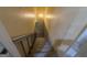 A brightly lit set of stairs with a handrail leads down to the basement level at 421 Safari Cir, Stone Mountain, GA 30083