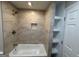 An updated bathroom provides a tile tub and shower, along with open shelving at 421 Safari Cir, Stone Mountain, GA 30083
