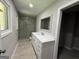 Modern bathroom with a large vanity, marble countertop, and a spacious walk-in shower at 421 Safari Cir, Stone Mountain, GA 30083