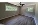 This bedroom features two windows for natural light and hardwood floors at 421 Safari Cir, Stone Mountain, GA 30083