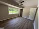 Bright bedroom with hardwood floors, a large window offering a private view, and a ceiling fan at 421 Safari Cir, Stone Mountain, GA 30083