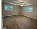 Bright bedroom featuring wood-look flooring and windows offering natural light and views at 421 Safari Cir, Stone Mountain, GA 30083