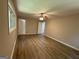 Bedroom featuring wood-look flooring, neutral walls, ceiling fan, and natural light at 421 Safari Cir, Stone Mountain, GA 30083