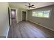 Bedroom with wood-look flooring, neutral paint, and a ceiling fan, offering a comfortable space at 421 Safari Cir, Stone Mountain, GA 30083
