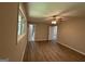 Bedroom featuring wood-look flooring, neutral walls, ceiling fan and ensuite bathroom at 421 Safari Cir, Stone Mountain, GA 30083