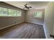 Light-filled bedroom with wood-look flooring, neutral paint, and windows offering natural views at 421 Safari Cir, Stone Mountain, GA 30083