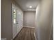 Welcoming foyer with hardwood floors, fresh paint, and natural light shining through a multi-paned sidelight at 421 Safari Cir, Stone Mountain, GA 30083