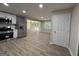 Open-concept kitchen boasts stainless steel appliances, new cabinets and flows seamlessly into the living room at 421 Safari Cir, Stone Mountain, GA 30083