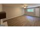 Bright living room featuring wood-look flooring, a ceiling fan, and large windows that provide natural light at 421 Safari Cir, Stone Mountain, GA 30083