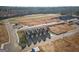 Aerial shot showcasing new townhomes with roadways, landscaping, and surrounding area at 123 Meadowview Dr # 15, Temple, GA 30179