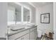 Stylish bathroom featuring double sinks, granite countertop, modern fixtures, and decorative wall art at 123 Meadowview Dr # 15, Temple, GA 30179