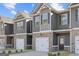 Street view of new construction townhomes with brick accents and attached garages at 123 Meadowview Dr # 15, Temple, GA 30179