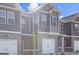 Exterior view of new townhomes featuring brick accents and attached garages at 123 Meadowview Dr # 15, Temple, GA 30179
