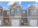 Townhome exterior with brick accents, attached garages, and neutral color scheme at 123 Meadowview Dr # 15, Temple, GA 30179