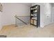 Second floor hallway with carpet, black metal railing, and a bookshelf at 123 Meadowview Dr # 15, Temple, GA 30179