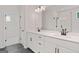 Bright bathroom with double sink vanity, tile floor, and glass-enclosed shower at 7530 W Homer Dr, Cumming, GA 30028