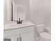 Modern bathroom featuring a white vanity, dark hardware, and tiled walls at 7530 W Homer Dr, Cumming, GA 30028