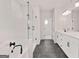 Stunning bathroom with dual sink vanity, glass shower, and tile flooring at 7530 W Homer Dr, Cumming, GA 30028