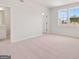 Bright primary bedroom with natural light, a bathroom, and a walk-in closet at 7530 W Homer Dr, Cumming, GA 30028