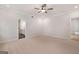 Large bedroom with neutral carpet, ceiling fan, and ensuite bathroom at 7530 W Homer Dr, Cumming, GA 30028